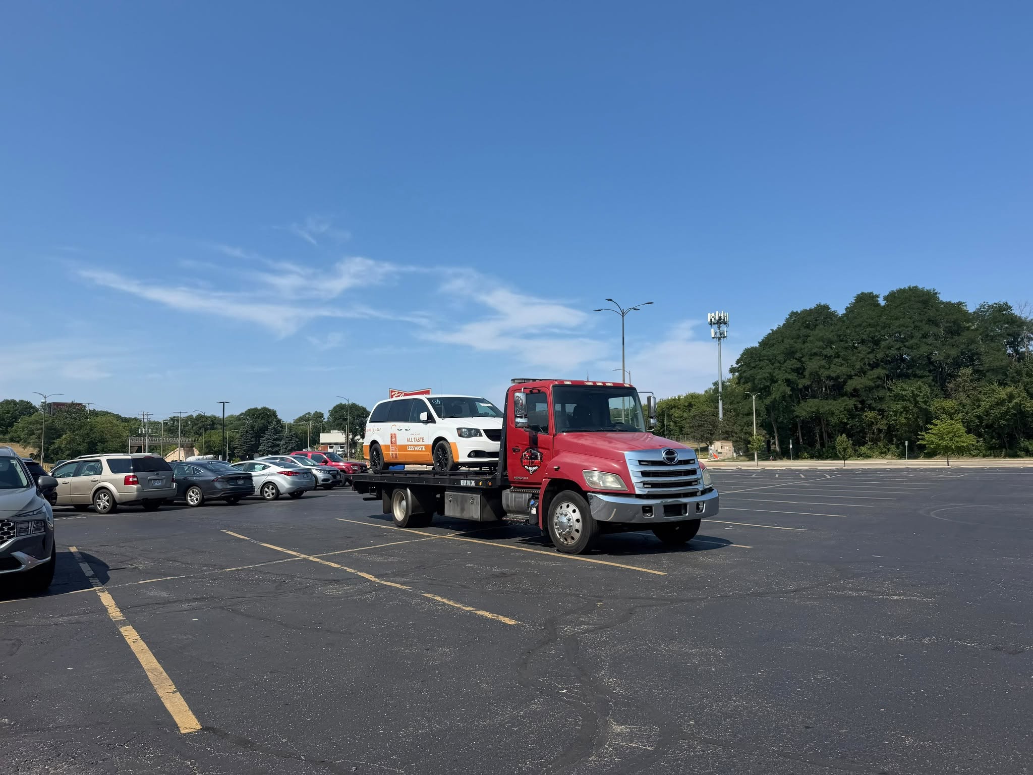 BBA Towing truck transporting a work van